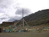 Tibet Kailash 08 Kora 08 Tarboche We drove westward from Darchen and entered the Lha Chu valley and stopped at the prayer-flag festooned Tarboche (4750m) pole. The pole is replaced each year at the major festival of Saga Dawa, marking the enlightenment of Shakyamuni. If the pole stands absolutely vertical all is well, but if it leans towards Kailash things are not good, if it leans away, things are even worse. Although we started our trek from Tarboche, you can drive to the Chuku bridge.